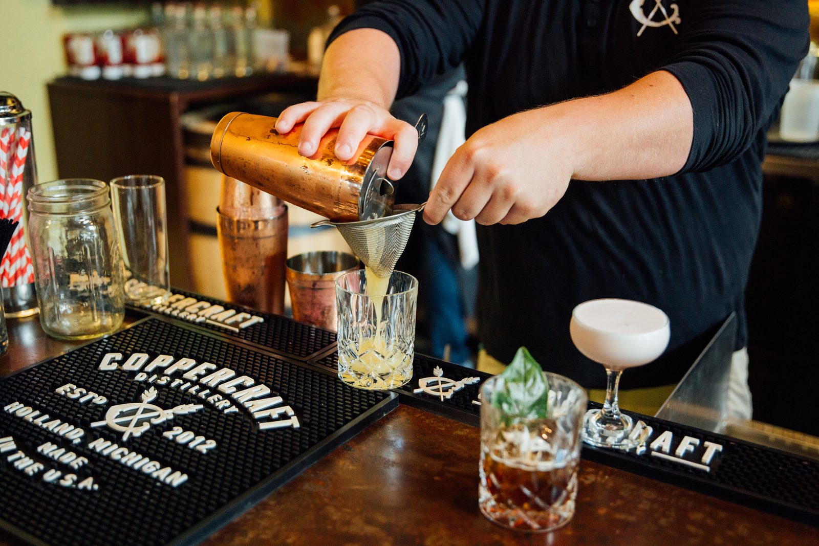 A cocktail being strained at the Coppercraft bar